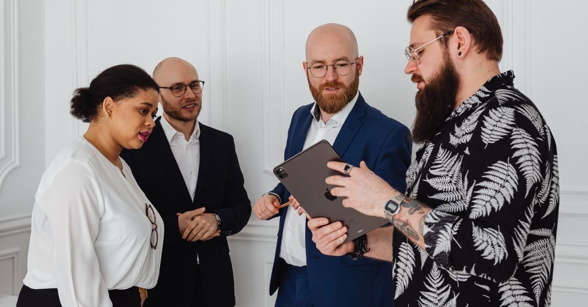 A team reviewing work together on a tablet